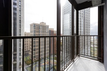 the balcony of an apartment on the upper floors of an apartment building