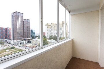the balcony of an apartment on the upper floors of an apartment building