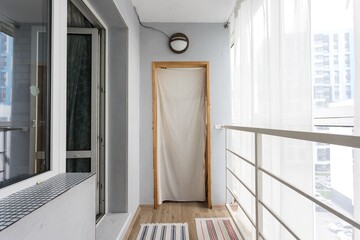 the balcony of an apartment on the upper floors of an apartment building