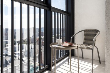 the balcony of an apartment on the upper floors of an apartment building