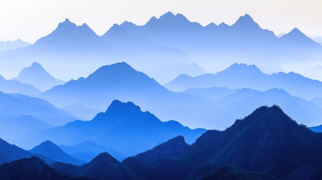 A misty mountain range with layers of peaks fading into the horizon.