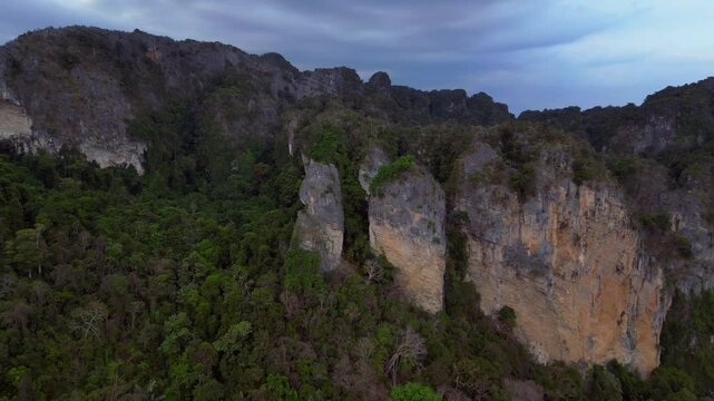 limestone cliffs emerging from tropical forest Dramatic aerial view flight drone