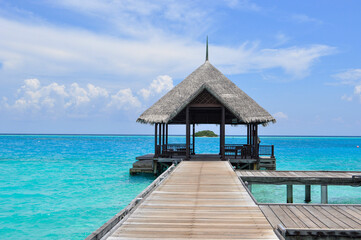 Tropical Paradise: Wooden jetty over turquoise waters in the Maldives.