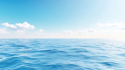 Obraz premium Vast expanse of tranquil ocean under a clear blue sky. A serene vista of the sea and sky, featuring gentle waves and fluffy white clouds against a vibrant azure backdrop.