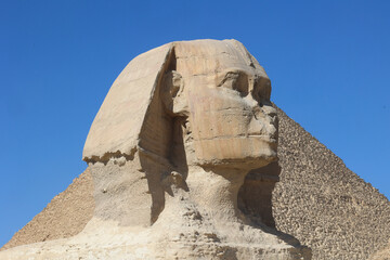 Side view of the Great Sphinx in the Giza pyramid complex, Cairo, Egypt. The limestone statue...