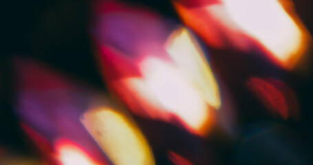 Kaleidoscope glow. Blur magic radiant. Defocused purple yellow orange lens reflection round light circles on abstract art dark black background.