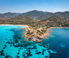 Obraz premium Aerial view of island, sea bay, beach, boats at summer sunny day. Travel in Sardinia, Italy. Top view from above of rocky coast, mountain, village, sea lagoon, transparent azure water, sky. Seascape