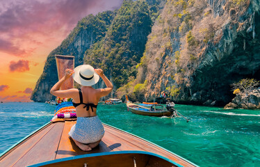 Traveler Beauty woman relaxing and enjoying at beautiful tropical white sand beach at Maya bay...