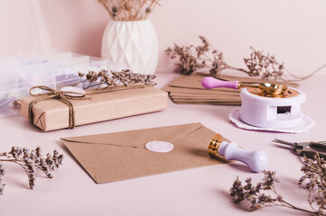 An envelope sealed with wax and a craft kit on the table