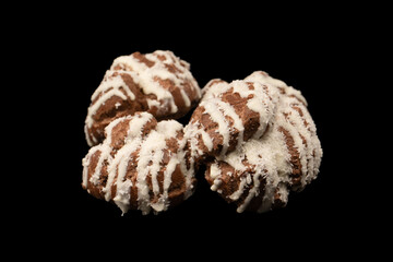 Profiteroles with coconut cream on a black background.