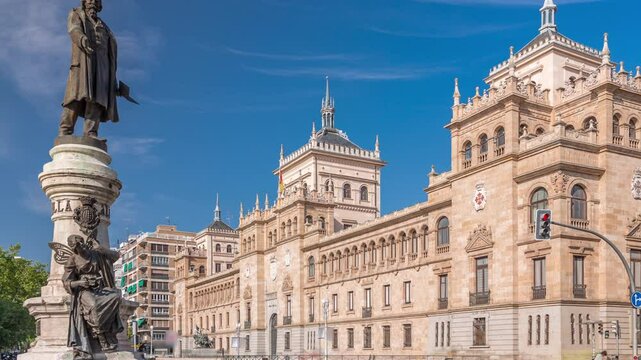 Timelapse of the Cavalry Academy in Plaza de Zorrilla, Valladolid, Spain. Historic military building with intricate architecture, surrounded by a busy urban scene under a blue sky with passing clouds.