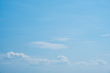 Sky. Blue sky with white clouds background. Curly clouds on a sunny summer day. Light cloudy. Good weather. Simple background sky for summer poster. Summer mock up. Soft focus.