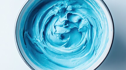 Creamy blue mixture in a bowl, thick consistency and smooth swirl design. -