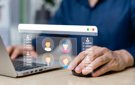 HR manager recruiting is reviewing the candidates profiles on the digital screen and adopting modern recruitment techniques in recruitment, employee evaluation and online screening.