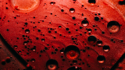 Bubble art. Sparkling fluid. Defocused red bronze color ink in water chemical liquid oil drop...