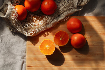 still life with oranges on a wooden cutting board