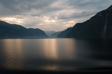 View from the Aida cruise ship at sunrise on the Storfjord with mountains in the background in Norway.