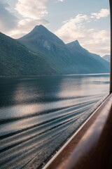 View from the Aida cruise ship at sunrise on the Storfjord with mountains in the background in Norway.