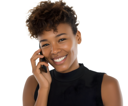 Cheerful young woman with curly hair smiles as she talks on her phone. She is wearing a sleeveless top and is isolated on a black background.