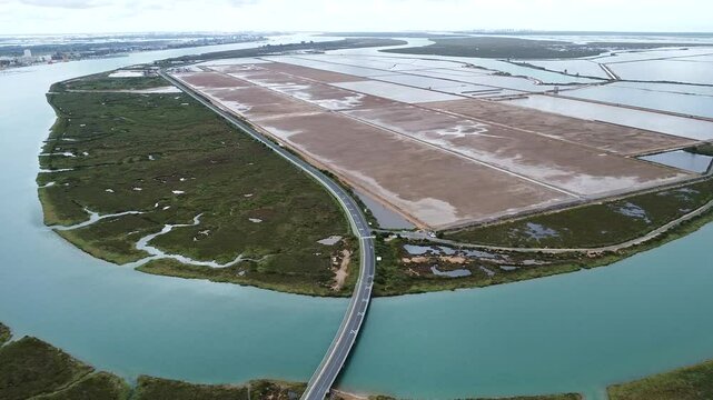Aerial drone view of empty sea salt marshes in Marismas del Odiel wetlands. Natural salt produced by the evaporation of seawater. Traditional and natural salt production in nature reserve, in Huelva