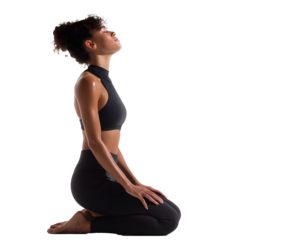 Young athletic woman in black workout clothes kneeling with her head back in a position of relaxation and well-being against black background.