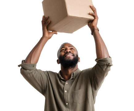 Man holding cardboard box with both hands, smiling up at it. He's wearing a green shirt, on a black backdrop.