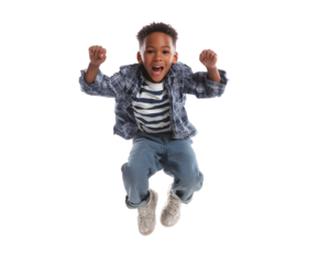 Excited boy leaps with joy in a mid-air pose. The child wears casual clothes and sneakers, looking joyful and carefree on a black backdrop.