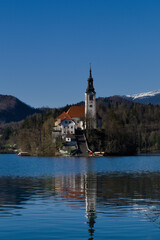 bled lake church with snowy mountain