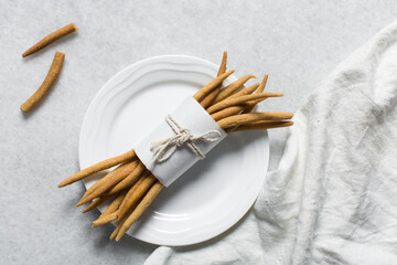 Top view of fried corn stick snack on a white plate, Overhead view of nigerian kokoro corn snack
