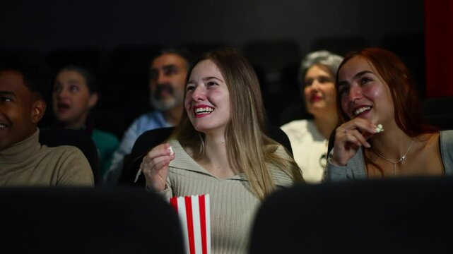 Friends enjoying a comedy movie at the cinema