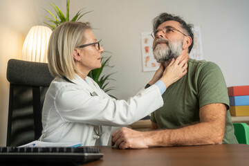Endocrinologist examining throat of man in clinic. Men with thyroid gland test . Endocrinology,...