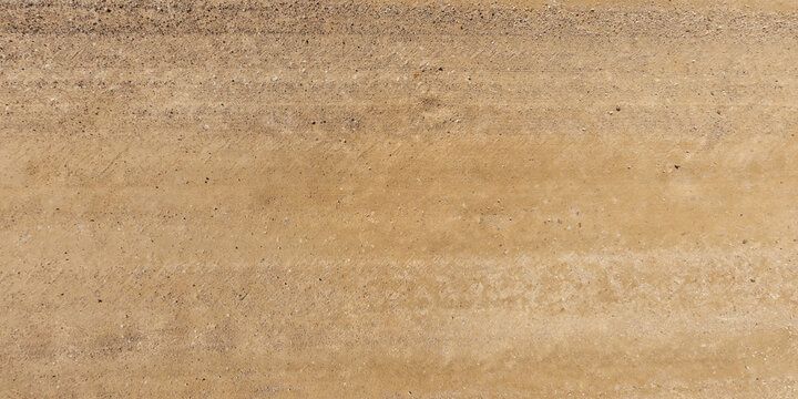 view from above on texture of dry road with tractor tire tracks in countryside.