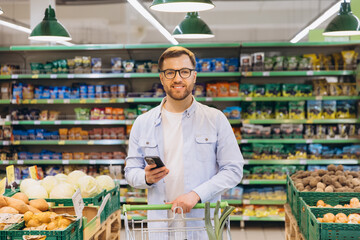 Customer Using Smartphone While Shopping in Supermarket