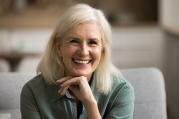Natural beauty of ages. Portrait attractive positive older woman on retirement with blond hair...