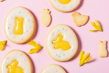 Easter egg cookies with lemon orange curd, covered with white icing and forsythia flowers.