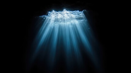 Sunlight piercing a dark underwater cave