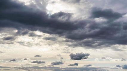 Dramatic dark storm clouds with the sun's rays. Fluffy clouds. Gloomy cloudy sky, gray clouds, wind. Rainy weather