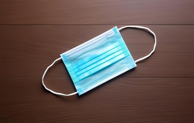 One surgical mask on a wooden table