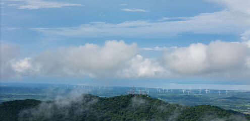 Naklejka premium Panorama of green valley with windmill turbine
