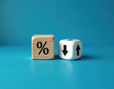 Wooden cube with percentage icon, dice with up down arrows on blue background. Interest rate changes, financial market fluctuations, economic growth, financial indicators, investment risk. Business,