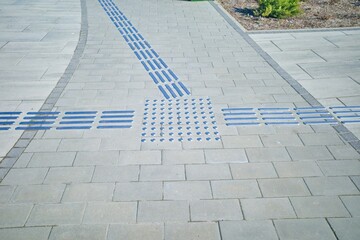 Intersection markings on the sidewalk for the visually impaired. Selective focus.