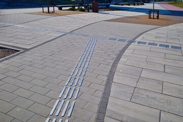 Intersection markings on the sidewalk for the visually impaired. Selective focus.