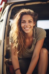 A happy girl sits in the doorway of a motorhome on a sunny beautiful day. Generative AI.