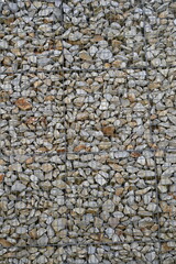 Close-up of a stone and iron mesh retaining wall, artificial retaining wall for crumbling hills 