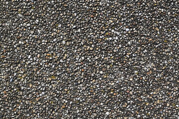 Natural gravel stone texture background with small pebbles and gray rocks. Close-up of rough surface used for construction, landscaping, or design materials.