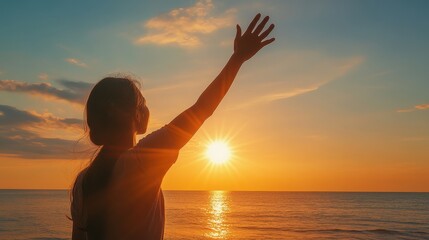 Fototapeta premium Embrace of Hope: Silhouette of a Helping Hand at Sunset on a Peaceful Beach