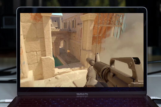 Counter-Strike 2 CS GO 2 first-person shooter game on screen showing player holding a rifle in a tactical urban map environment