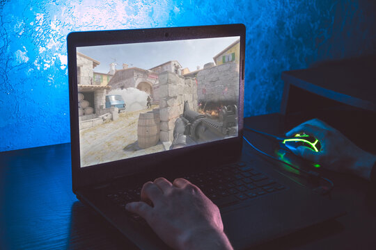  Counter-Strike 2 CS GO 2 first-person shooter game on screen showing player holding a rifle in a tactical urban map environment