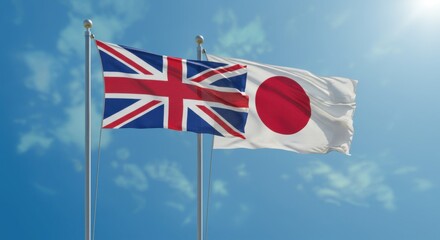 National Flags of the United Kingdom and Japan Flying Side by Side Against a Clear Blue Sky