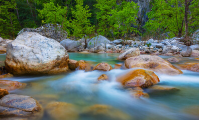 emerald mountain river rushing among huge stones